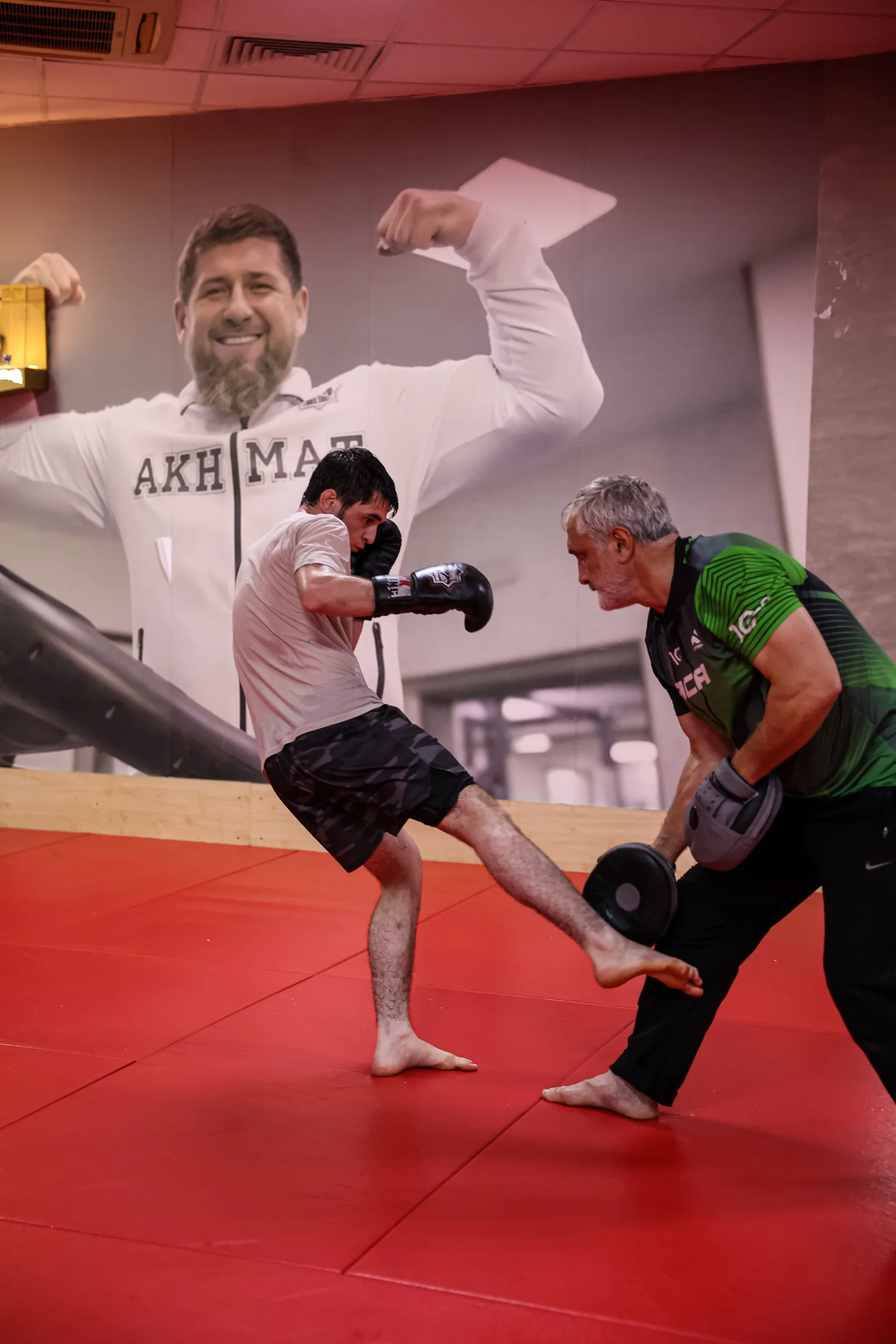 Kick haut sur pad, coach barbe blanche
